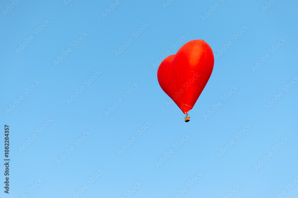 romantic red heart balloon soaring in the clear blue sky on a sunny day romantic red heart balloon soaring in the clear blue sky on a sunny day