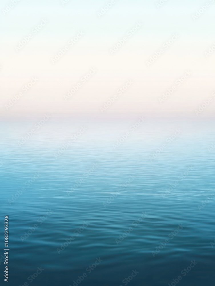 Obraz premium A serene view of calm ocean waters blending with a pastel sky.