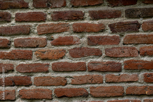 Antique clay brick wall with gray cement lines. Concept: Bricks, wall, vintage, background, industrial.