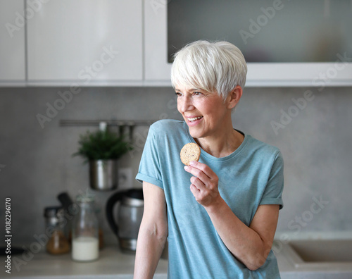 kitchen woman healthy morning mature breakfast active fitness milk cookie dessert calories eating drink drinking lactose protein nutrition vitamin dairy