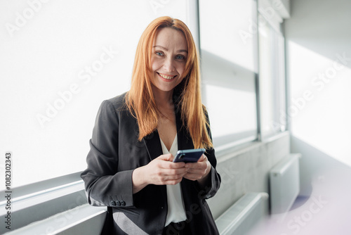 Businesswoman Using Smartphone in Modern Office