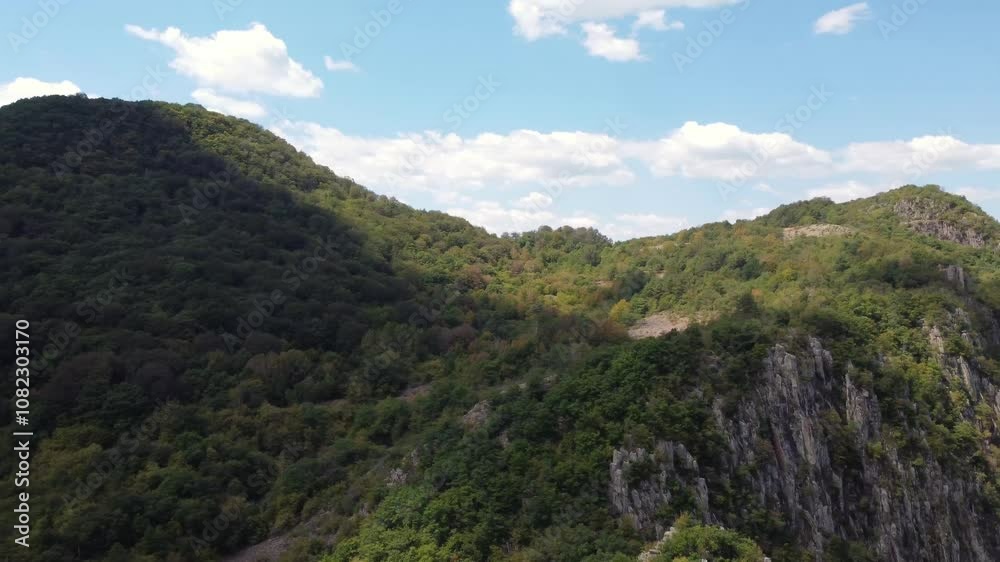 A flight above a dense forest and hills, revealing a breathtakingly lush valley under a bright blue sky. Dynamic shadows and vibrant greenery, picturesque exploration of untouched nature. A flight above a dense forest and hills, revealing a breathtakingly lush valley under a bright blue sky. Dynamic shadows and vibrant greenery, picturesque exploration of untouched nature.