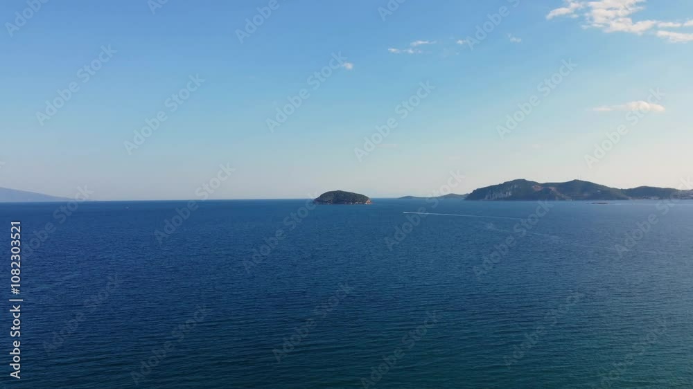 A smooth, forward drone shot over the azure sea, revealing distant islands and the vast horizon. Highlights the beauty of the water, sky, and remote islands, offering a cinematic perspective. A smooth, forward drone shot over the azure sea, revealing distant islands and the vast horizon. Highlights the beauty of the water, sky, and remote islands, offering a cinematic perspective.