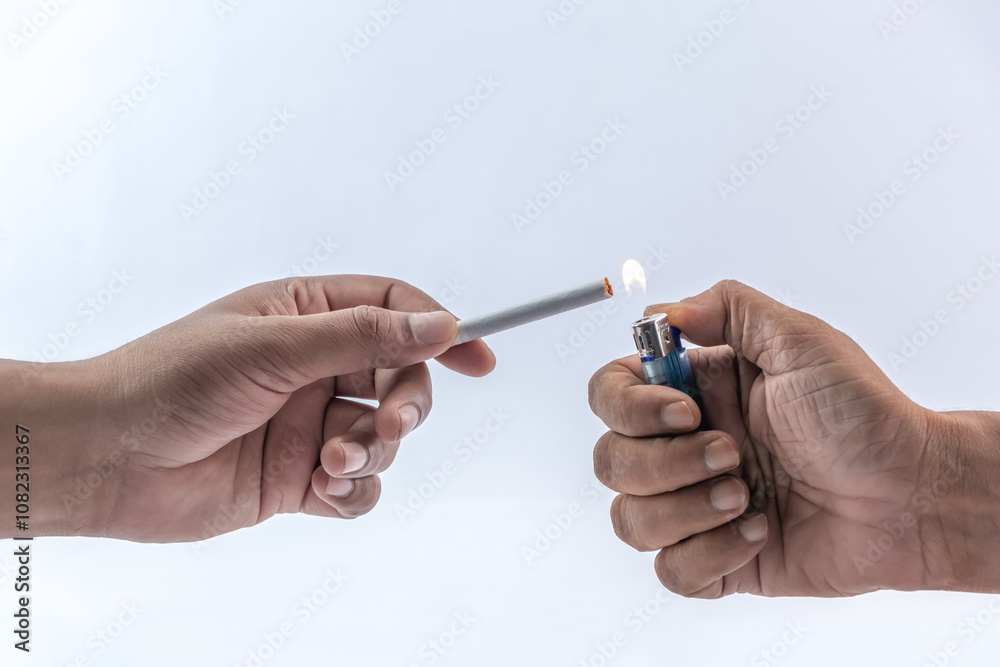 The hand is lighting a cigarette on a white background. The hand is lighting a cigarette on a white background.