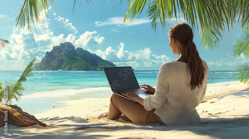 Businesswoman with her laptop open on a beach vacation photo