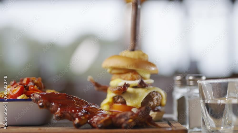 close up portrait shot of the combo burger dish of a restaurant with some bacons served on a wooden plate close up portrait shot of the combo burger dish of a restaurant with some bacons served on a wooden plate