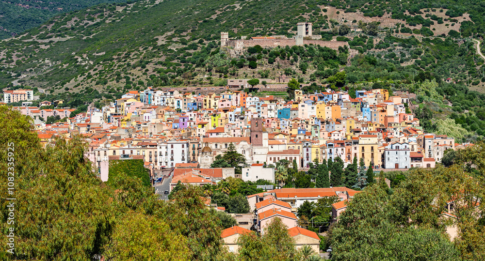 Fototapeta premium Panoramic view of the colorful buildings of Bosa and the Castle of Serravalle. Oristano, Sardinia, Italy