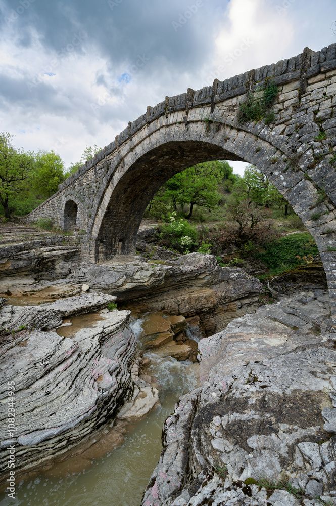 View of the traditional stone Bridge of Greci in Epirus, Greece in Spring. View of the traditional stone Bridge of Greci in Epirus, Greece in Spring.