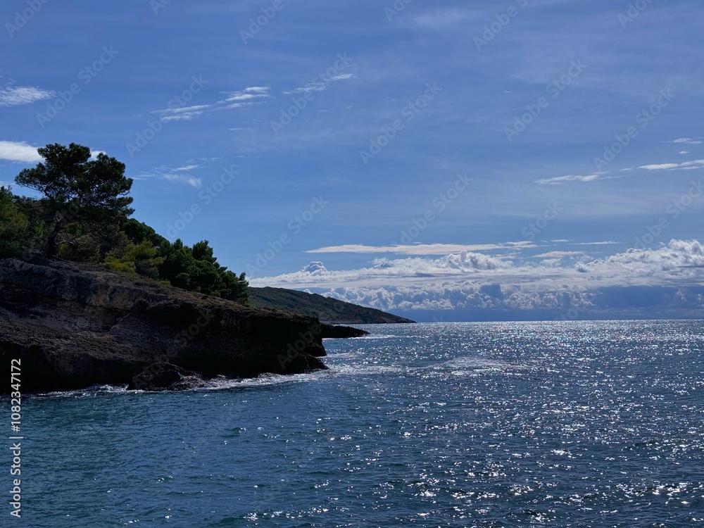 Blue sparkling sea and scenic rocky coast Blue sparkling sea and scenic rocky coast