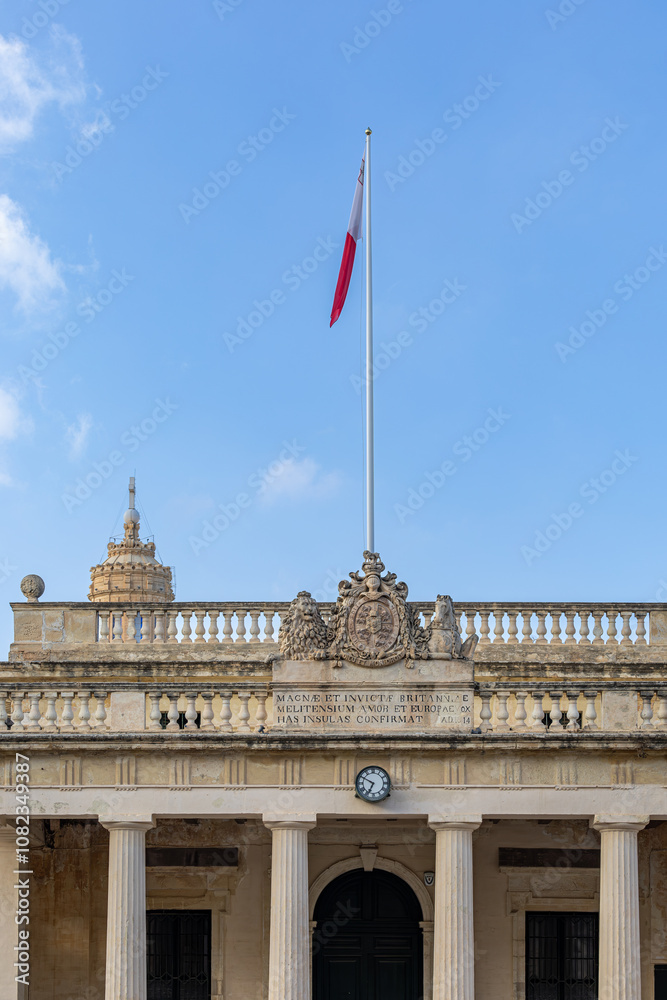 Fototapeta premium Valletta, Malta A Maltese flag flies over St. George’s Square.