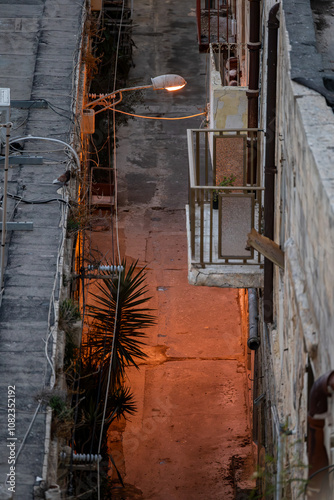 Valletta, Malta An old illuminated street at night with no people in the Old City of Valletta. photo