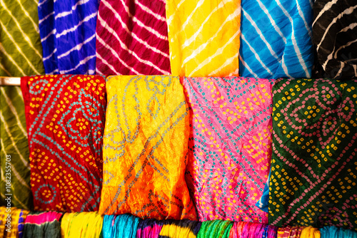 Macro shot of tie and dye clothes hanging in a shop with multiple colors and patterns showing the traditional clothing of Rajasthan