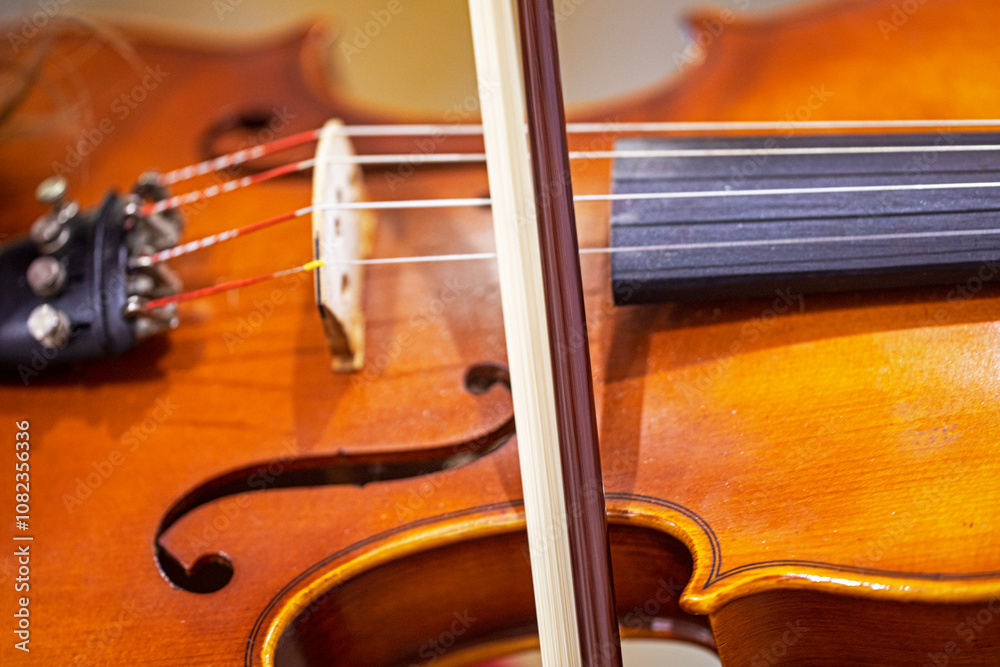 student violin with strings close-up with bow student violin with strings close-up with bow