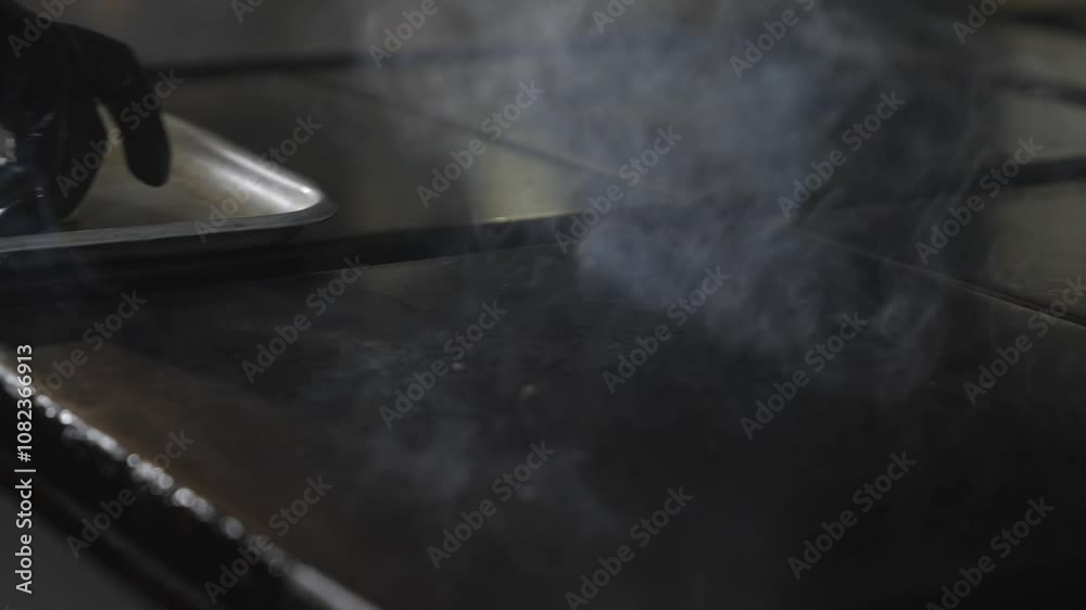 Chef setting up the kitchen pan for frying some meat Chef setting up the kitchen pan for frying some meat