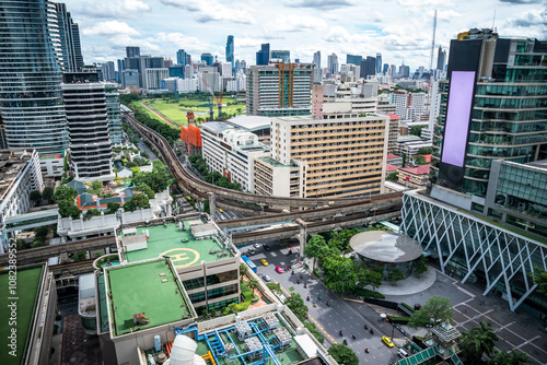 Bangkok Aerial Skyline and Skytrain view of Thailand. Business and financial building area centers with smart green park among urban city at noon time. photo