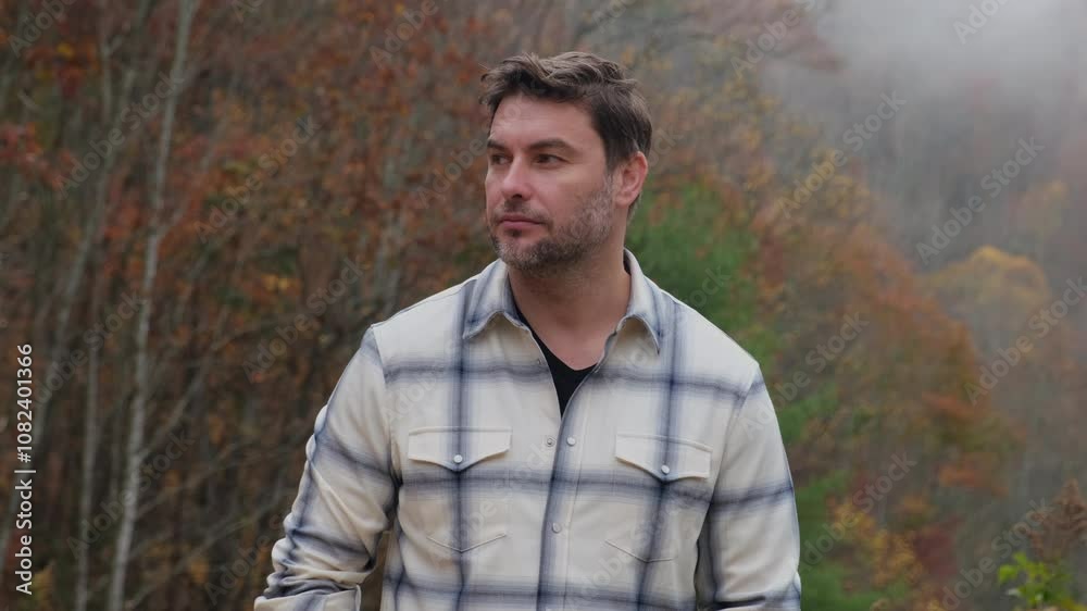 portrait of a farmer of a man with a smile in a forest in the mountains. Brutal bearded man. Bearded handsome lumberjack in a forest, checked shirt. Brutal bearded lumberjack with ax in winter forest. portrait of a farmer of a man with a smile in a forest in the mountains. Brutal bearded man. Bearded handsome lumberjack in a forest, checked shirt. Brutal bearded lumberjack with ax in winter forest.