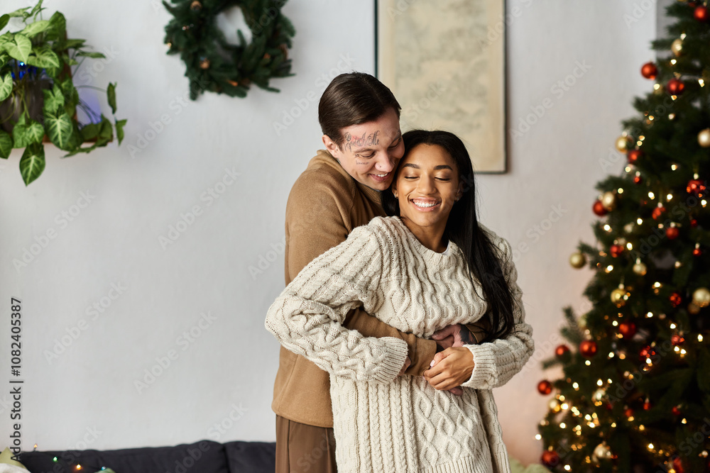 A joyful couple shares a warm embrace, celebrating the love of Christmas together at home. A joyful couple shares a warm embrace, celebrating the love of Christmas together at home.