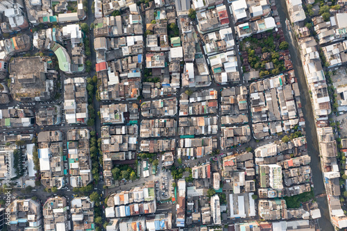 A high shot topview reveals the endless maze of houses and housing that make up the bustling city of Bangkok, each one teeming with activity. shot date 6 Nov 2018.