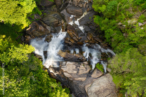 Amazing summer landscape with forest river waters falling down in big waterfall with clear water between rocky boulders in Nantahala National Forest. Whitewater Falls, North Carolina, USA photo