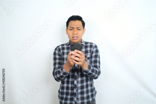 asian man angry texting on smartphone isolated on white wear casual shirt