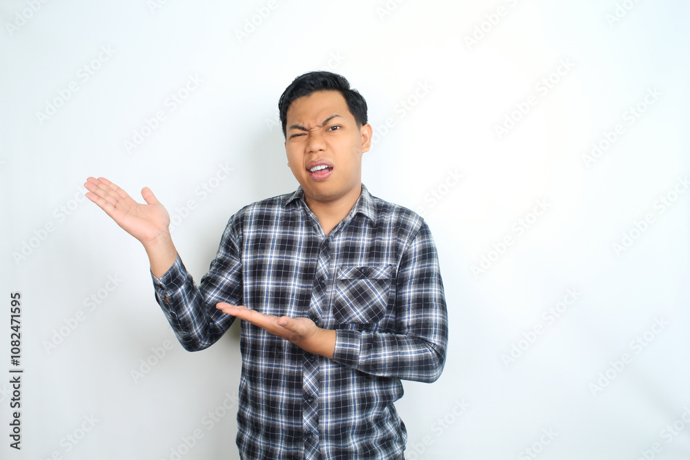 thoughtful asian man pointing hand with clueless expression wearing casual clothes isolated oh white thoughtful asian man pointing hand with clueless expression wearing casual clothes isolated oh white