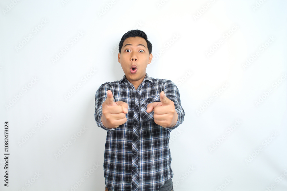 shocked asian man pointing hand with surprised funny expression isolated on white shocked asian man pointing hand with surprised funny expression isolated on white