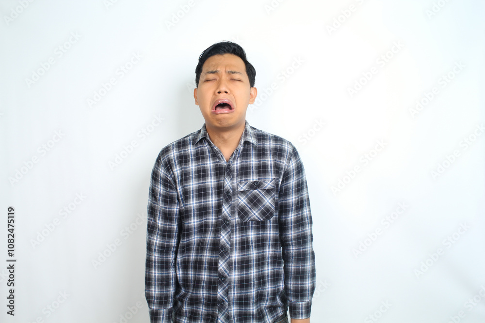 sad asian man crying isolated on white background, male wearing plaid shirt sad asian man crying isolated on white background, male wearing plaid shirt