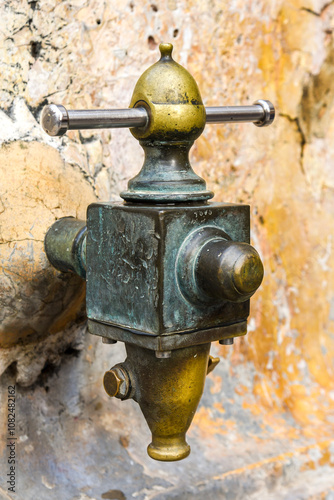 Obraz na płótnie vintage street water faucet in a fountain in Tarragona, spain, made of metal w salonie