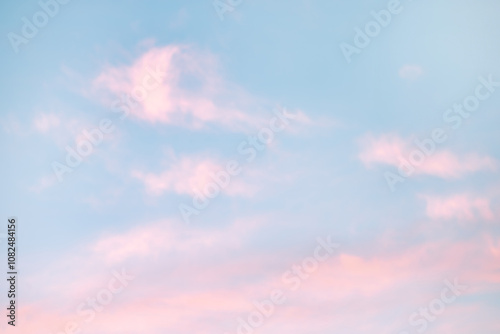 A beautiful sky tinted by the sun leaving vibrant shades of gold, pink, blue and multicolored. Clouds in the twilight evening and morning sky. Cloudy sky background in the evening, and during the day.