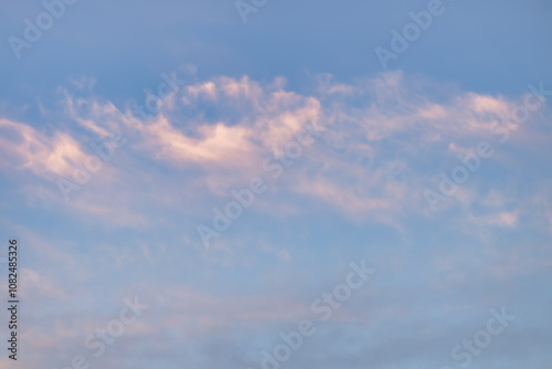 A beautiful sky tinted by the sun leaving vibrant shades of gold, pink, blue and multicolored. Clouds in the twilight evening and morning sky. Cloudy sky background in the evening, and during the day.