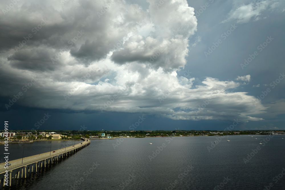 Heavy thunderstorm approaching traffic bridge connecting Punta Gorda and Port Charlotte over Peace River. Bad weather conditions for driving during rainy season in Florida Heavy thunderstorm approaching traffic bridge connecting Punta Gorda and Port Charlotte over Peace River. Bad weather conditions for driving during rainy season in Florida