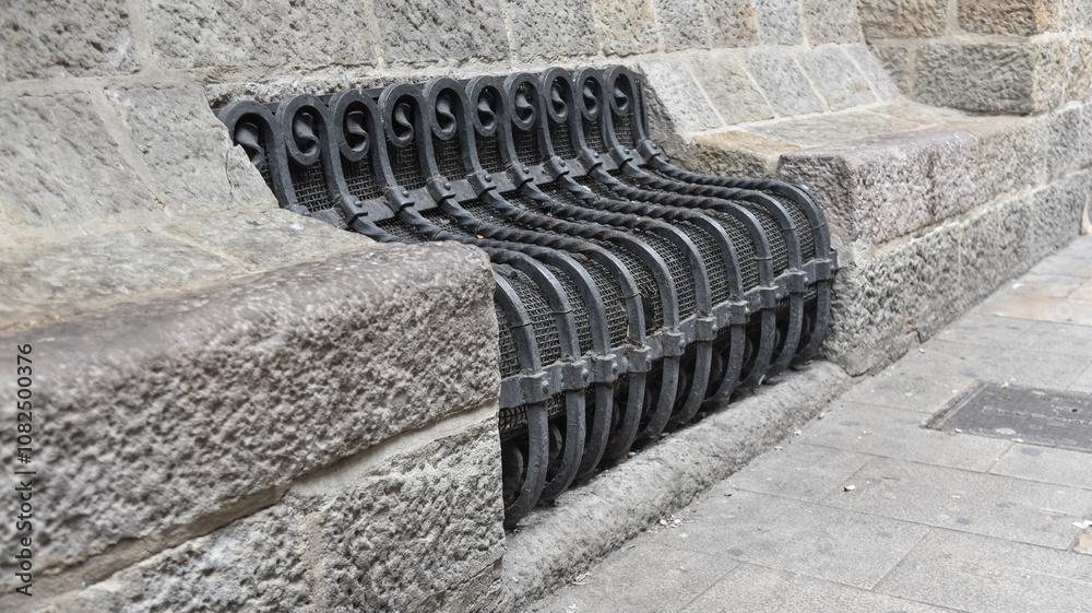 an iron bench in the old streets of Barcelona Spain