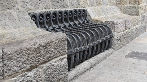 an iron bench in the old streets of Barcelona Spain