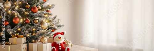 hristmas Tree with Ornaments and Gifts Next to Santa Doll photo