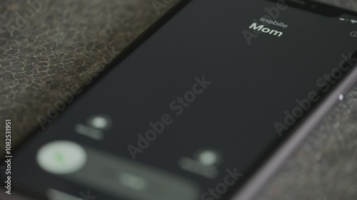 Incoming call from Mom on smartphone macro video.