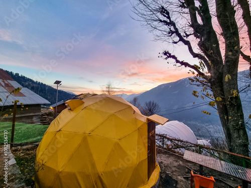 geodesic and swiss tents overlooking manali valley at sunset at a popular glamping spot near hampta village for eco freindly and comfortable adventure stays photo