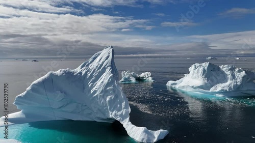 Huge icebergs floating in the water off the coast of Greenland, close to Oqaatsut near Ilulissat. Aerial view.