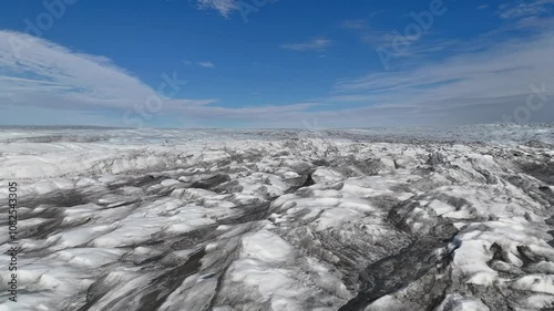 Vast aerial view of the Greenlandic ice cap during sunshine wiht blue sky, near Kangerlussuaq. photo