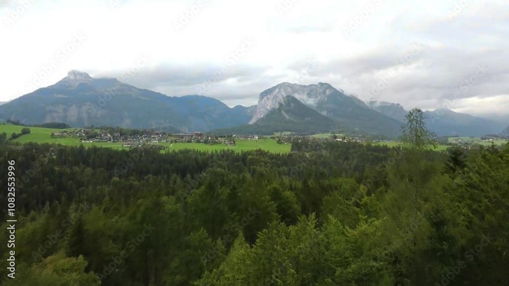 drone view, grey clouds hang low over mountain ran
