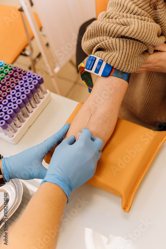 Medical professional performing blood draw procedure with precision in a clinical setting