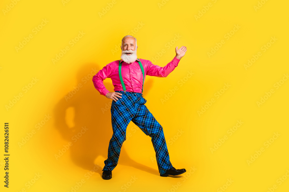 Full size photo of old gentleman dance point empty space dressed glamour stylish outfit party isolated vibrant yellow color background Full size photo of old gentleman dance point empty space dressed glamour stylish outfit party isolated vibrant yellow color background