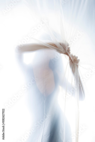 Mysterious Woman Behind Frosted Plastic Sheet in Abstract Studio Setting