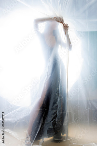 Mysterious Woman Behind Frosted Plastic Sheet in Abstract Studio Setting