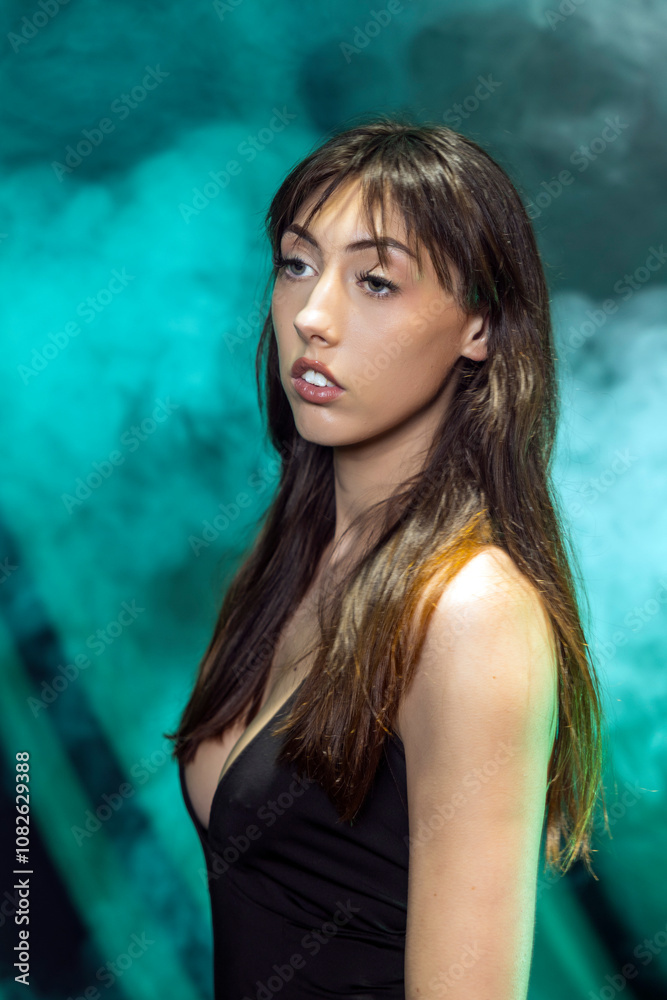 Portrait of Woman in Black Dress Against Smoky Green Backdrop Portrait of Woman in Black Dress Against Smoky Green Backdrop