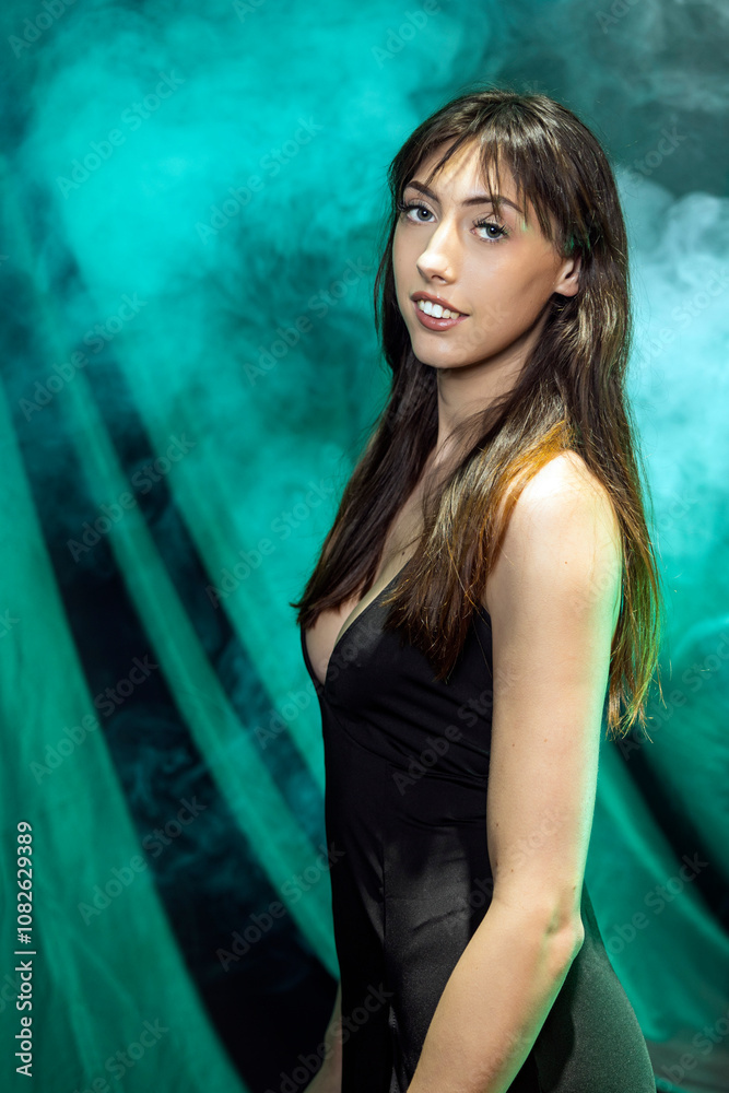 Fototapeta premium Portrait of Woman in Black Dress Against Smoky Green Backdrop