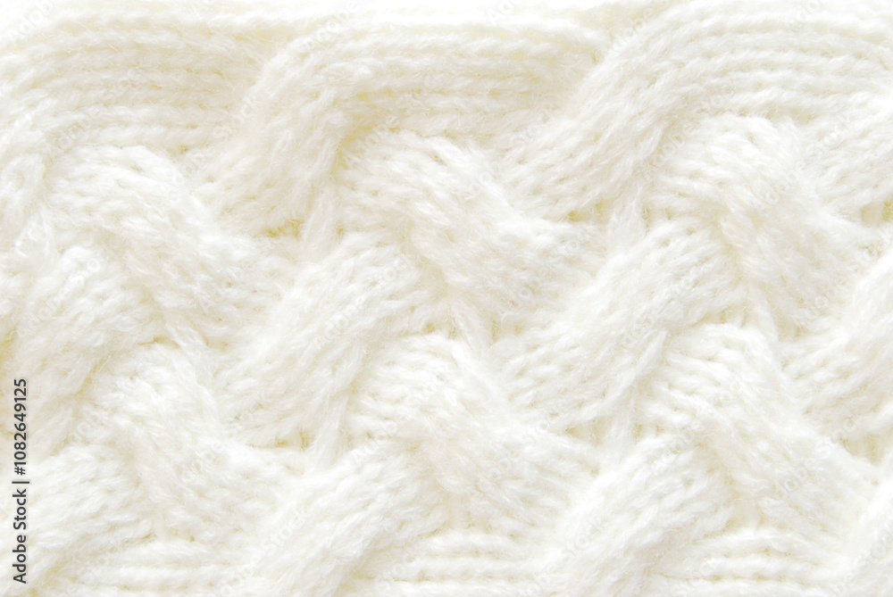 Soft white braid cable stitch pattern or texture as background Soft white braid cable stitch pattern or texture as background