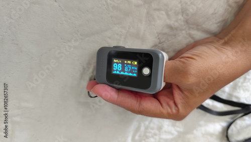 pulse oximeter on the finger of a woman patient. a device to monitor oxygen in the human body