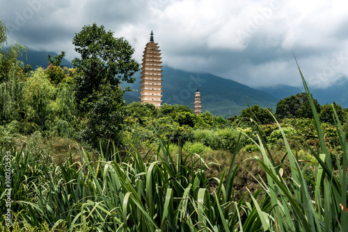 Ancient Pagodas Amidst Lush Greenery and Mountain Backdrop