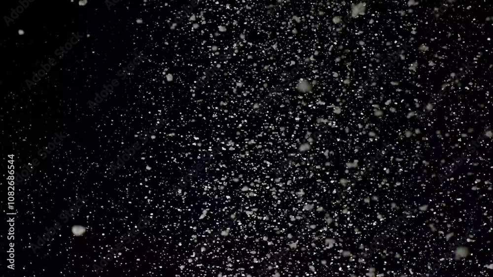 A dense heavy blizzard snowstorm VFX insert in slow-motion on black screen. Black screen Christmas snowstorm. Particles swirling moved by wind. Snow is moving through space. Snowstorm on black. A dense heavy blizzard snowstorm VFX insert in slow-motion on black screen. Black screen Christmas snowstorm. Particles swirling moved by wind. Snow is moving through space. Snowstorm on black.
