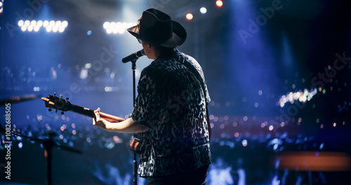 Portrait of a Handsome Young Man Singing a Country Song and Playing Guitar at a Music Festival. Cinematic Neon Spotlights Illuminates the Star, His Romantic Presence and Lyrics Electrify the Stage